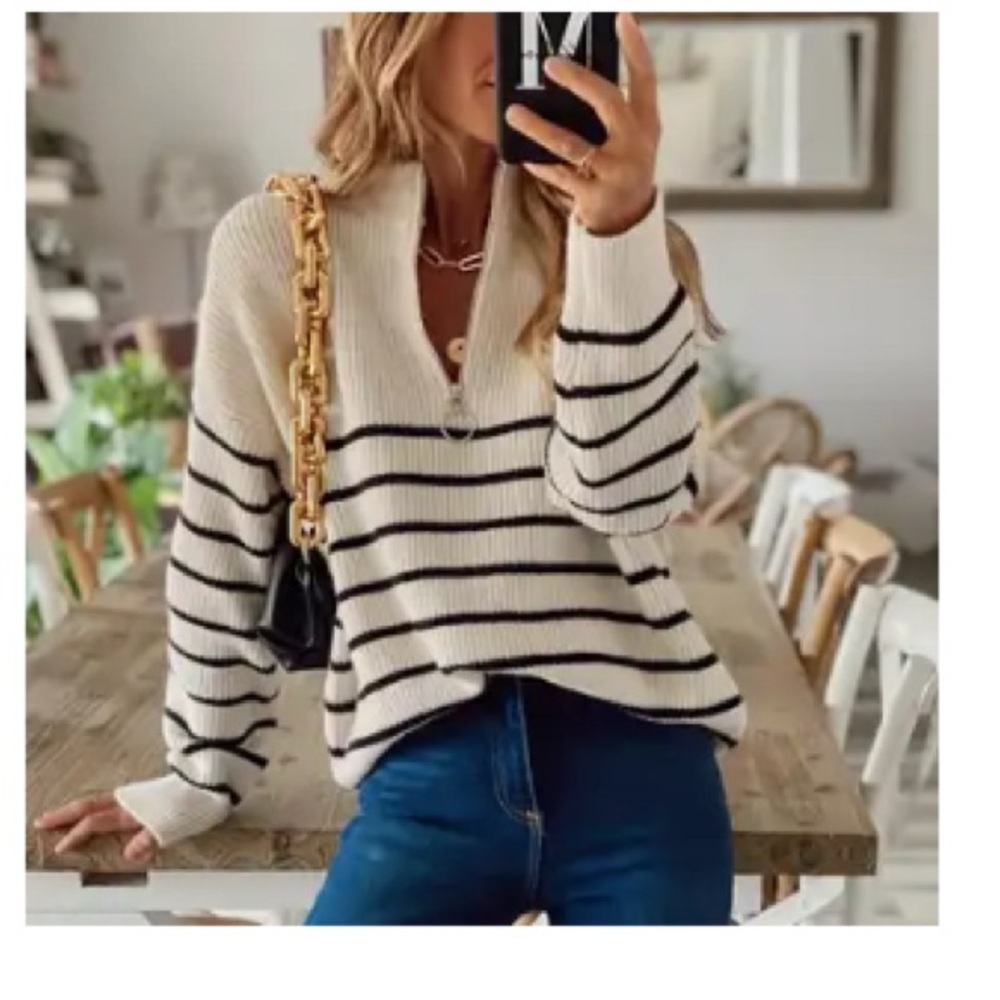 Casual black and creamy white sweater with silver quarter zip. Oversized small.